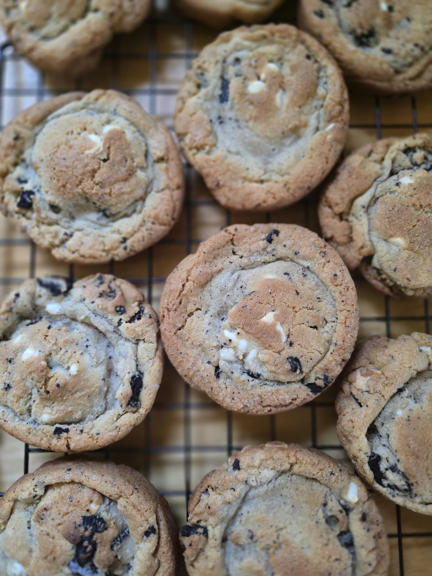 Fresh chocolate chip cookies arranged together after baking.