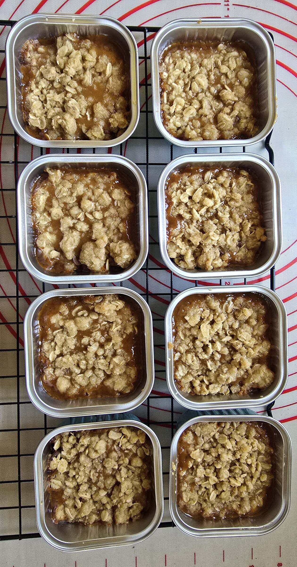 Eight mini sweet bread loaves topped with a golden crumble.